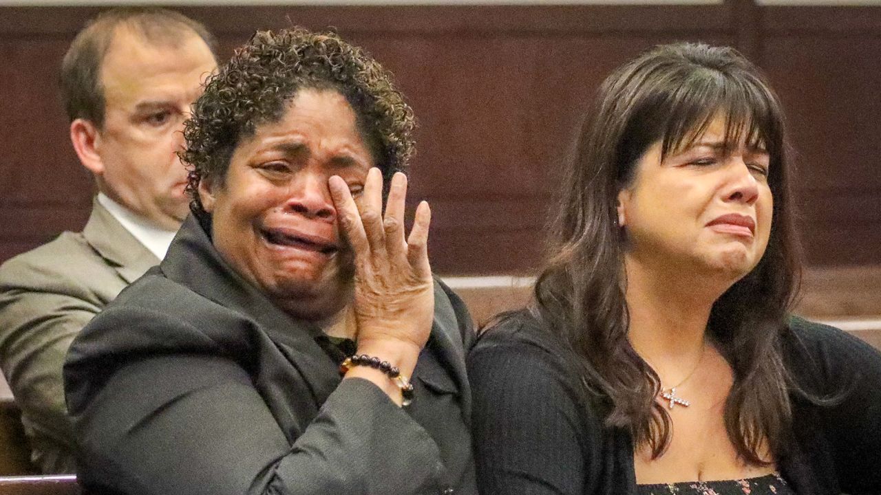 Shelina Reneau, a family friend to murder victim Monica Hoffa, left, and Yury Gutierrez, Hoffa's cousin, center, react as a state prosecutor describes Hoffa's murder during Howell Emanuel Donaldson III's plea hearing on Monday.