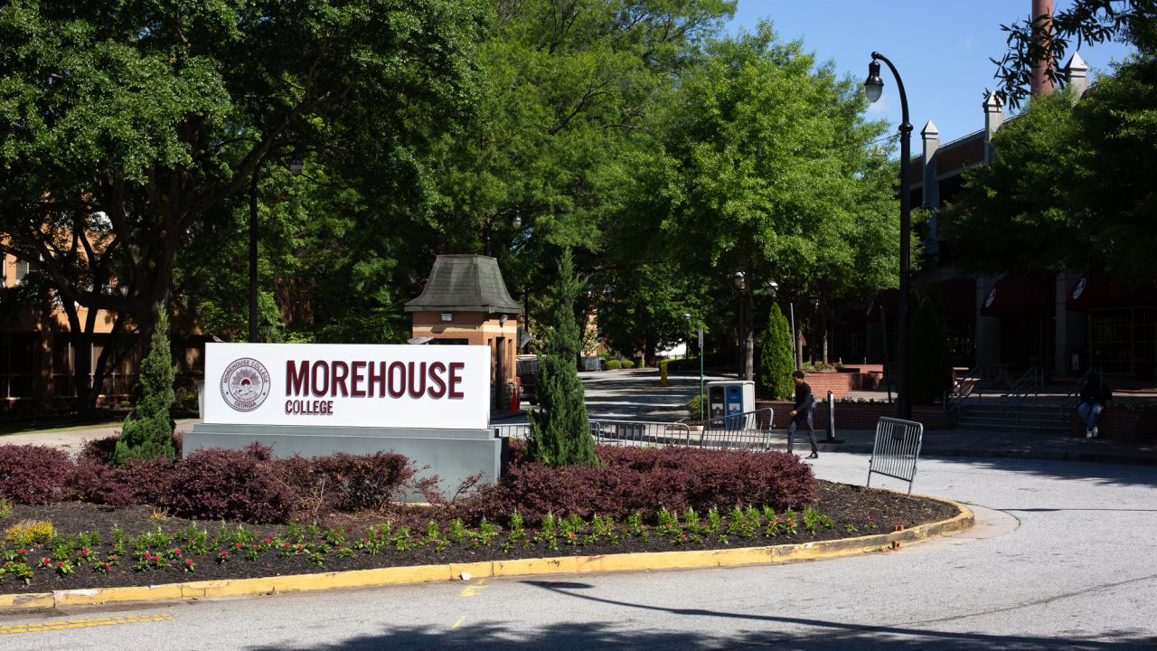 A person walks by the sign for Morehouse College in Atlanta on May 1, 2023.