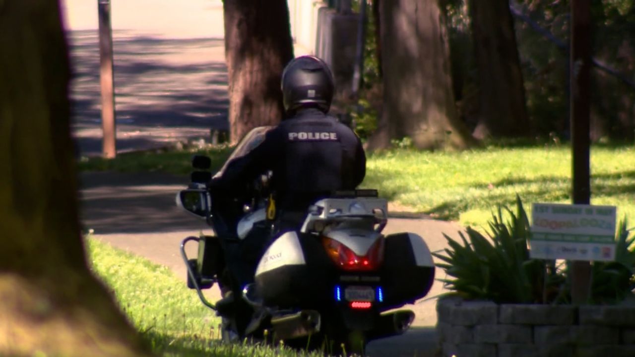 A police officer patrols a park in Davis, California, on April 30, 2023.