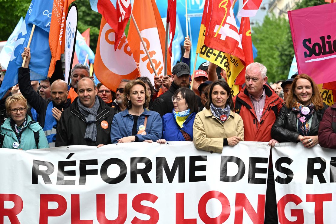 French trade union officials take part in a demonstration in Paris on May 1, 2023, after the government pushed an unpopular pensions reform act through parliament.