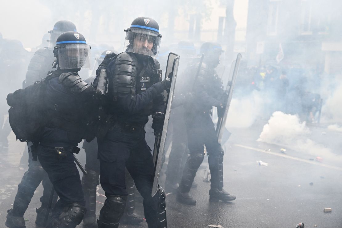 Policemen look on during Monday's demonstrations, with fierce clashes between security officials and protesters leading to dozens of arrests.