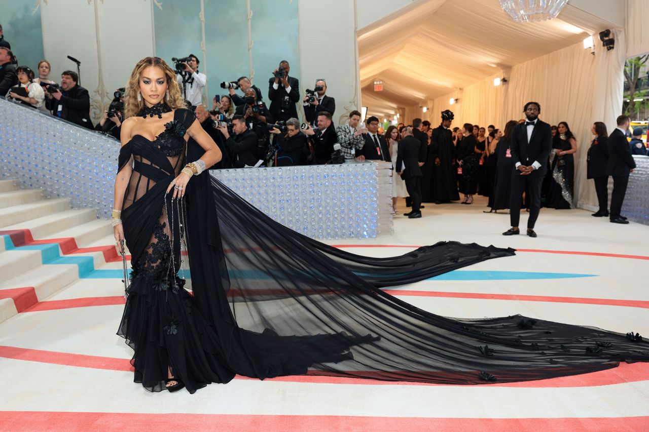 Rita Ora embraced high drama in a romantic, sheer black Prabal Gurung gown that included two trains cascading out far behind her.
