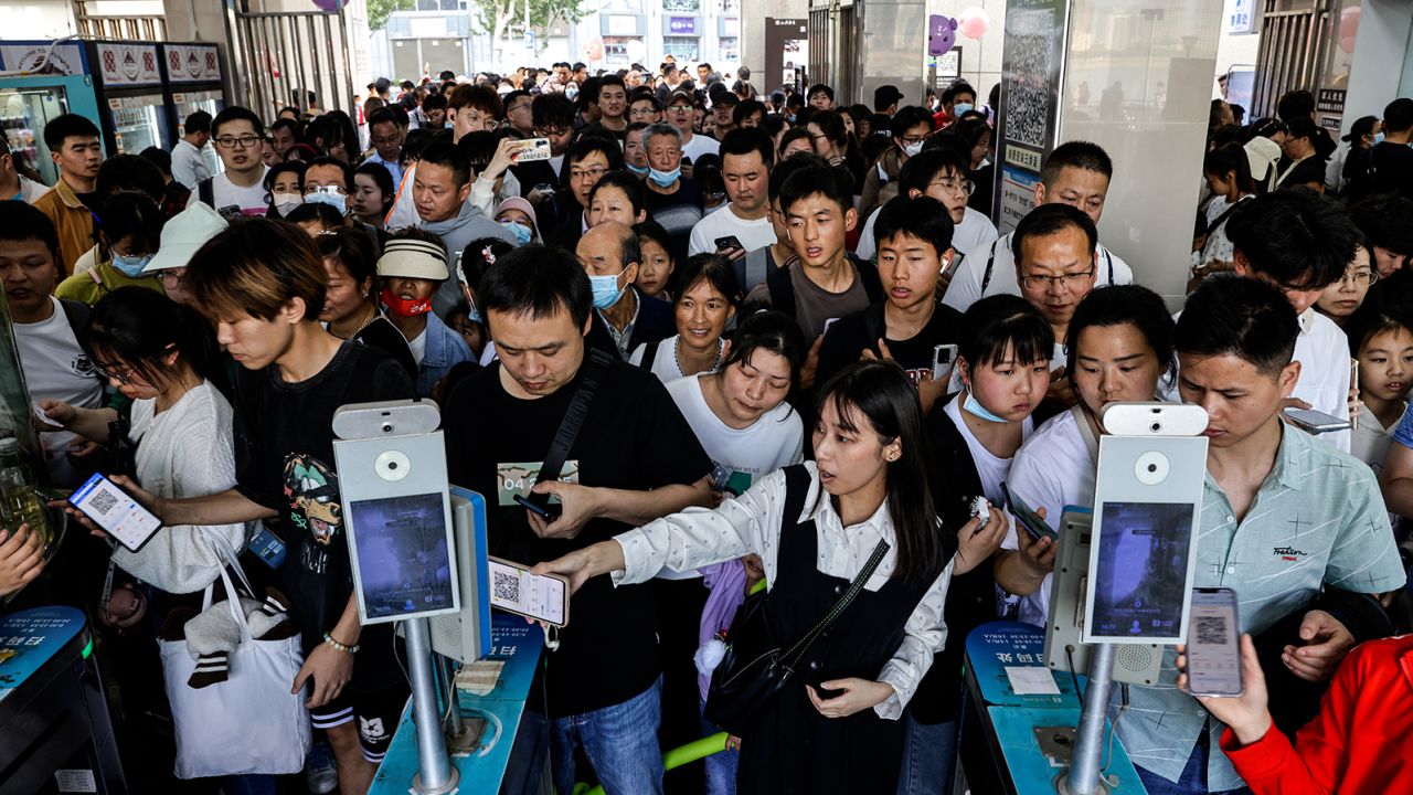 People line up to get on a ferry at a popular tourist attraction in Wuhan, a city in central China. 