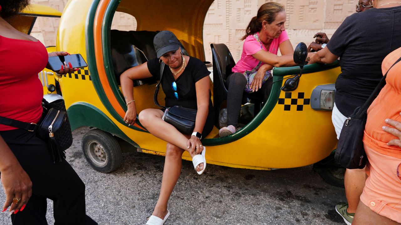 Taxi drivers wait in line to fill fuel at a petrol station in Havana.