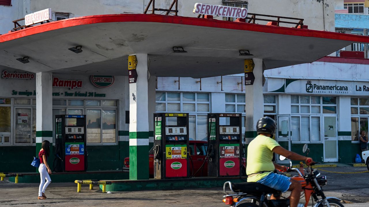 A man riding a motorcycle passes by an empty gas station in Havana on April 24, 2023.