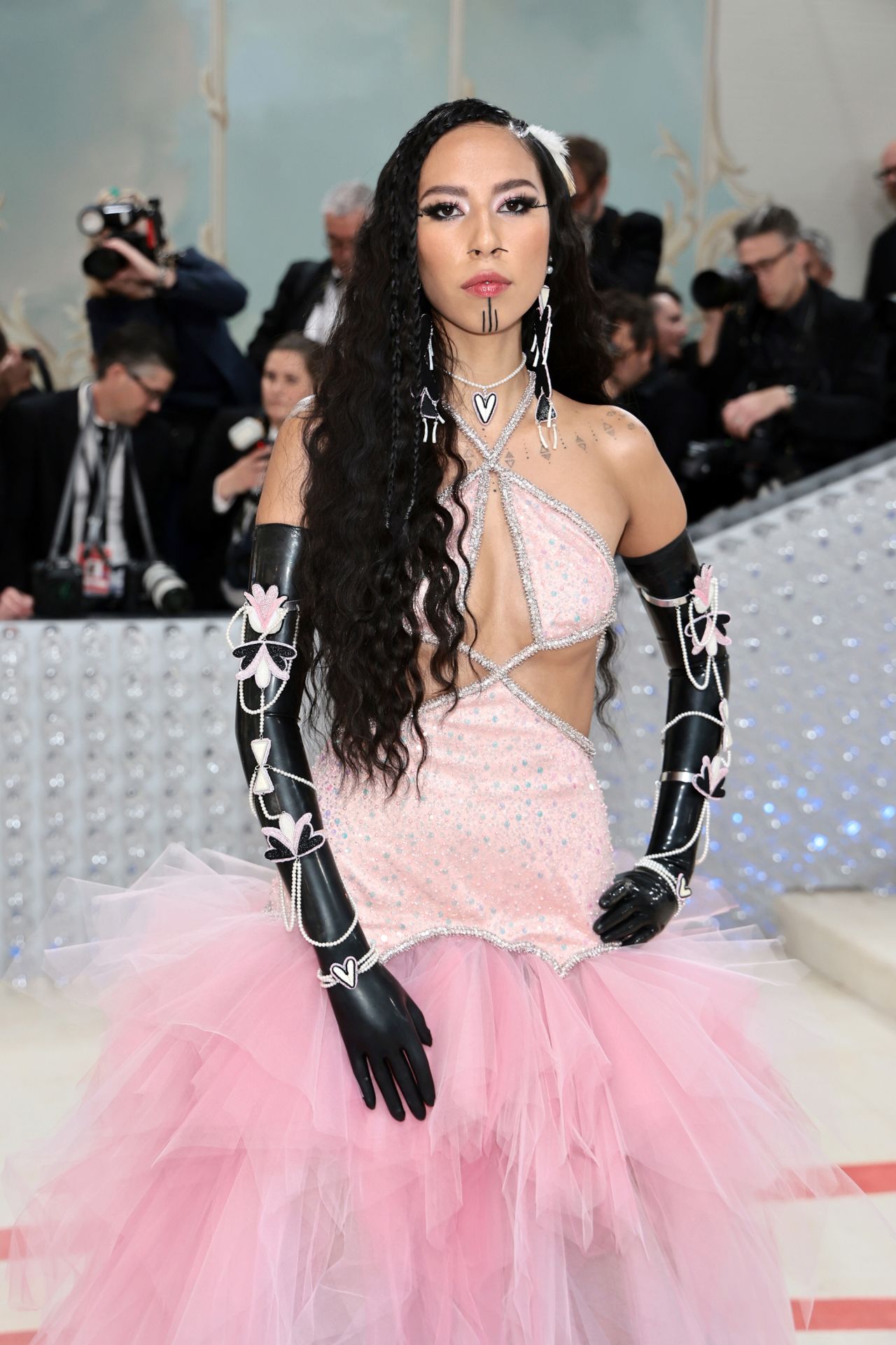 Model Quannah Chasinghorse in a pink tulle Prabal Gurung gown, black Vex Latex gloves and Indigenous jewelry.
