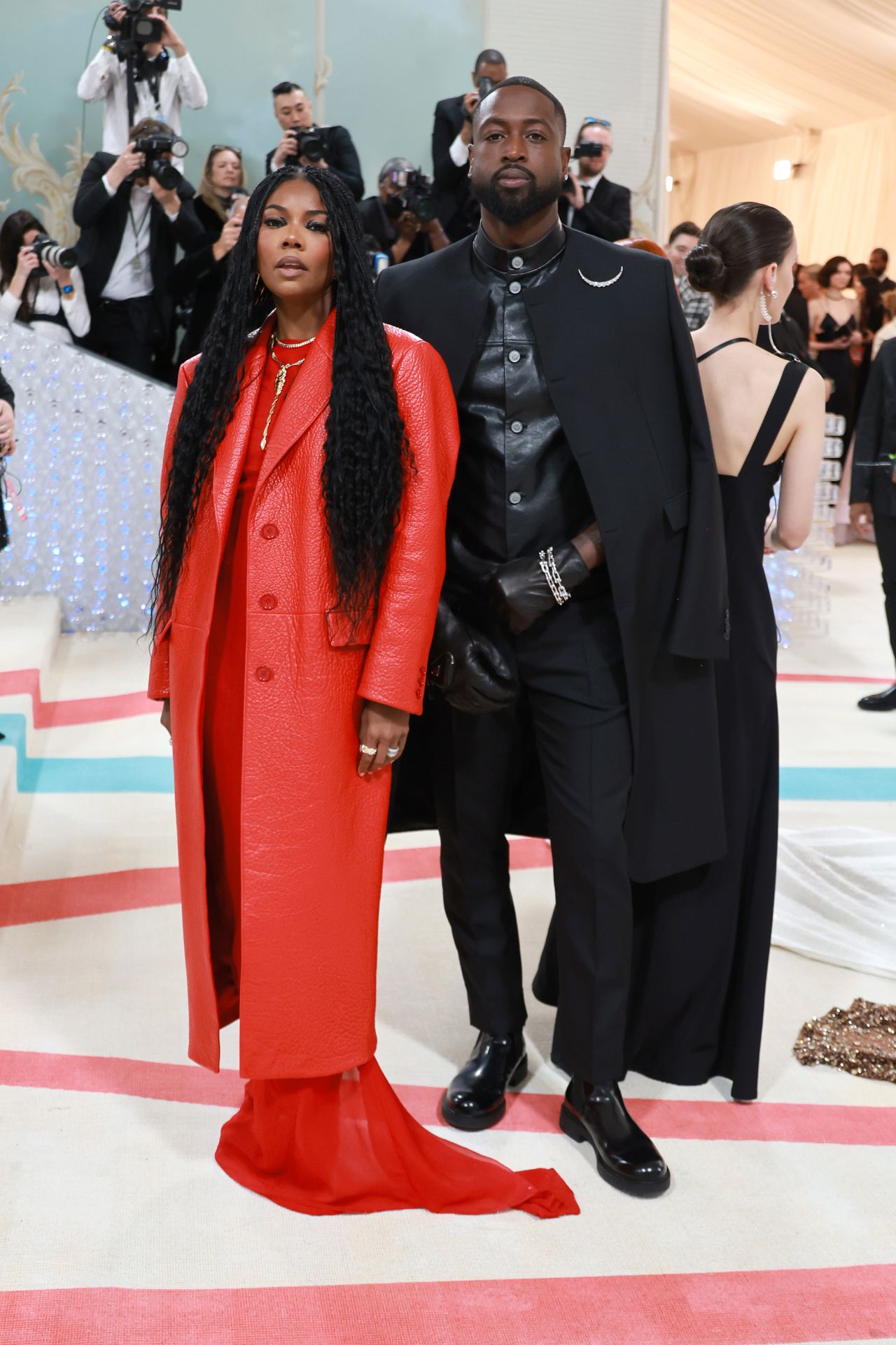 Gabrielle Union and Dwyane Wade did outerwear right with complementary leather in red and black, both from Prada.
