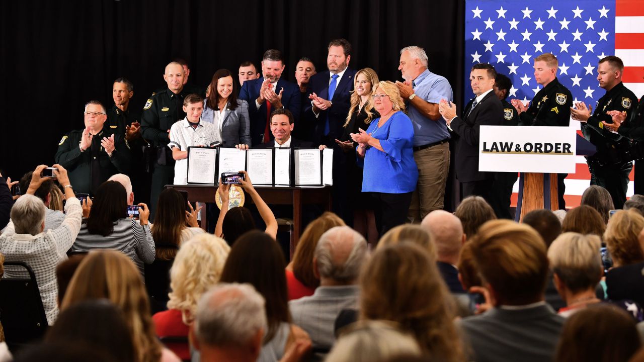 Gov. Ron DeSantis signs three bills in Titusville, Florida, on Monday, appearing with state Attorney General Ashley Moody at the American Police Hall of Fame and Museum.