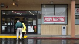 People walk by a now hiring sign posted in front of a CVS store on April 07, 2023, in San Rafael, California. 