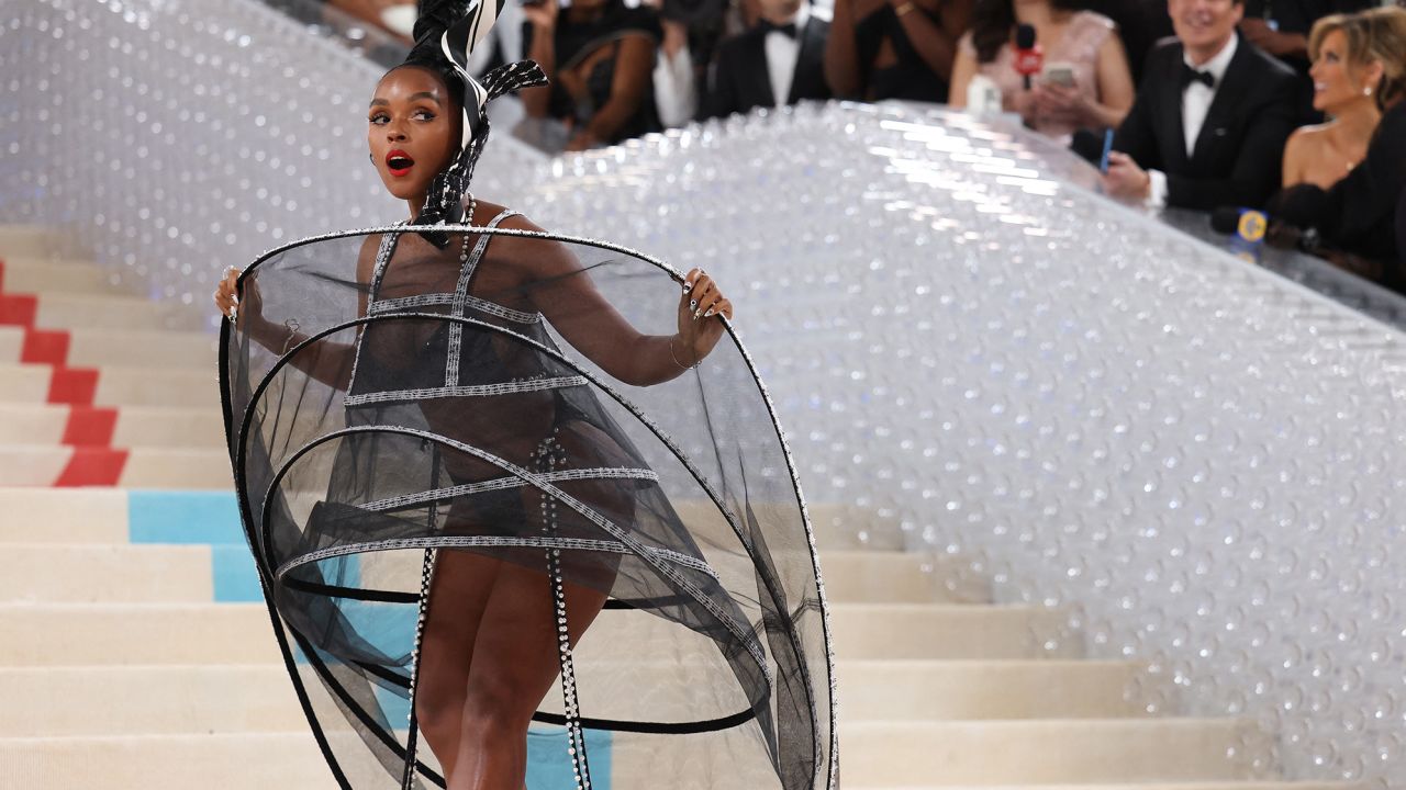 Janelle Monae revealed a wired underdress beneath an oversized coat.