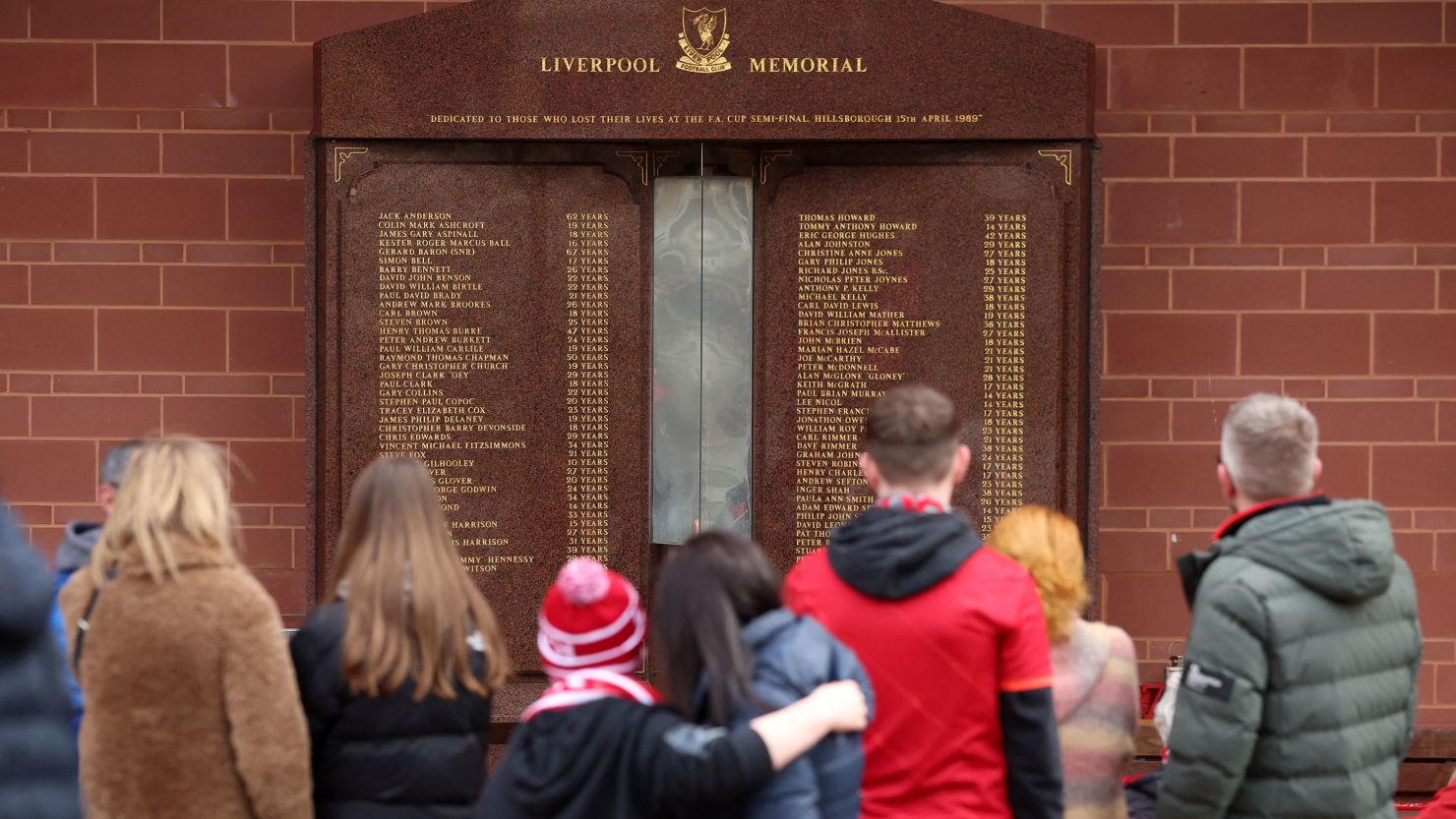 Fans look at the memorial in memory of the victims of the Hillsborough disaster outside Anfield.