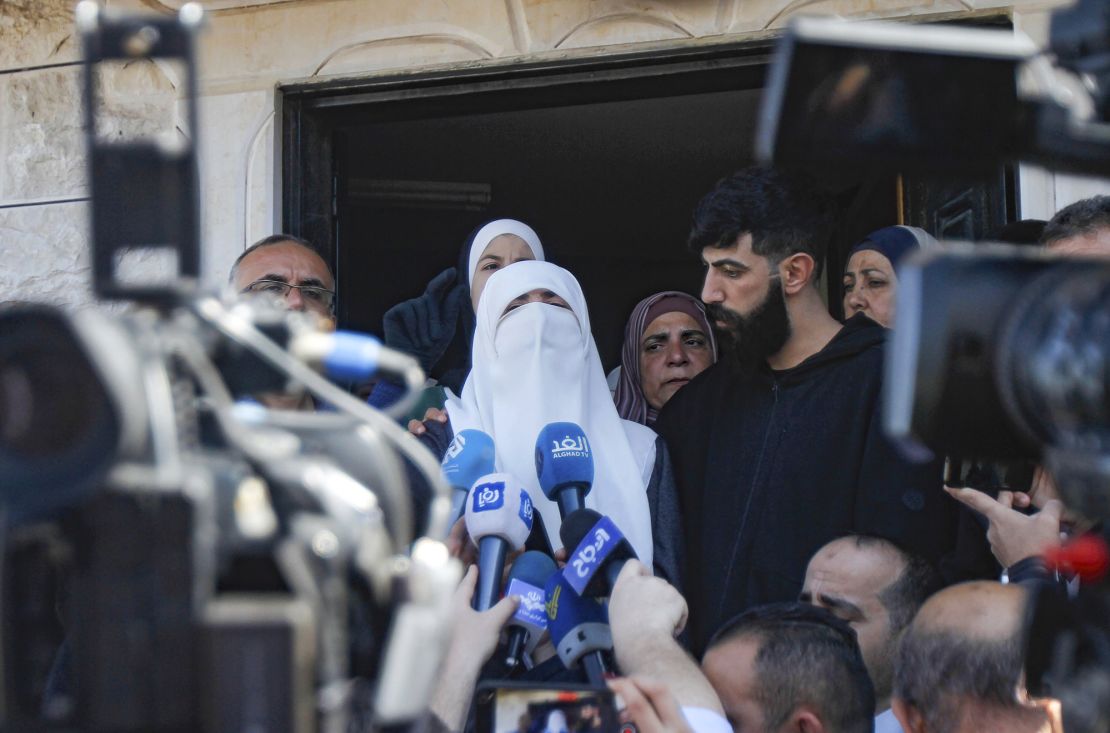 Adnan's wife (center) speaks at a vigil in front of his home in the village of Arraba near Jenin in the West Bank. His lawyer told CNN Israel has not yet returned his body to the family.