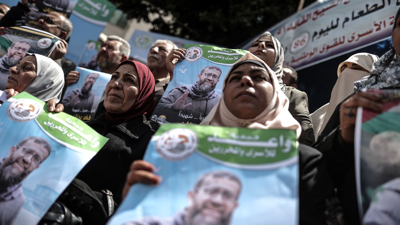 People gather to demonstrate against Adnan's death in front of the International Committee of the Red Cross (ICRC) building in Gaza City, on Tuesday.