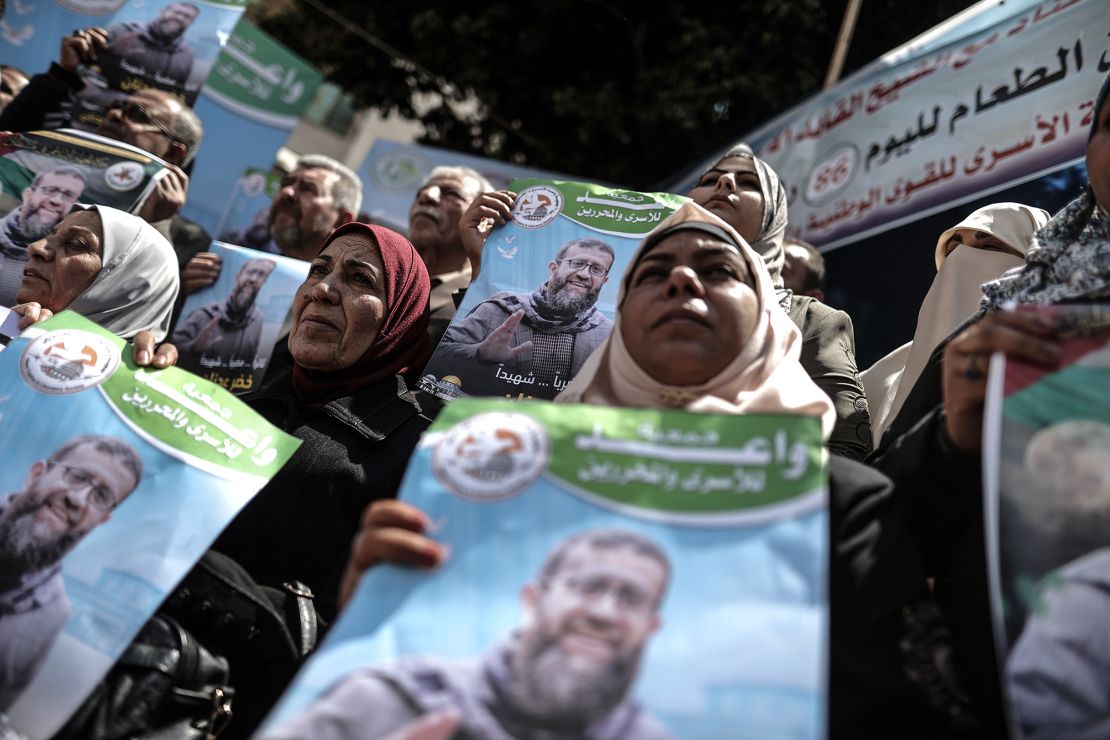 People gather to demonstrate against Adnan's death in front of the International Committee of the Red Cross (ICRC) building in Gaza City, on Tuesday.