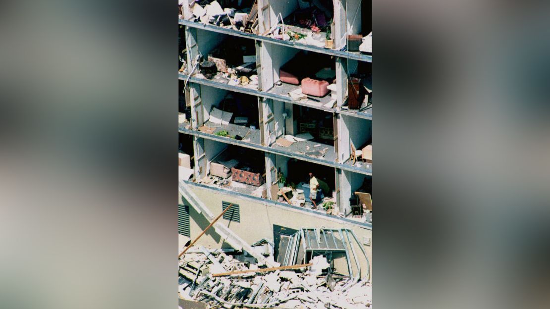 A resident looks out of his apartment after Hurricane Andrew in August 1992 blew away its walls.