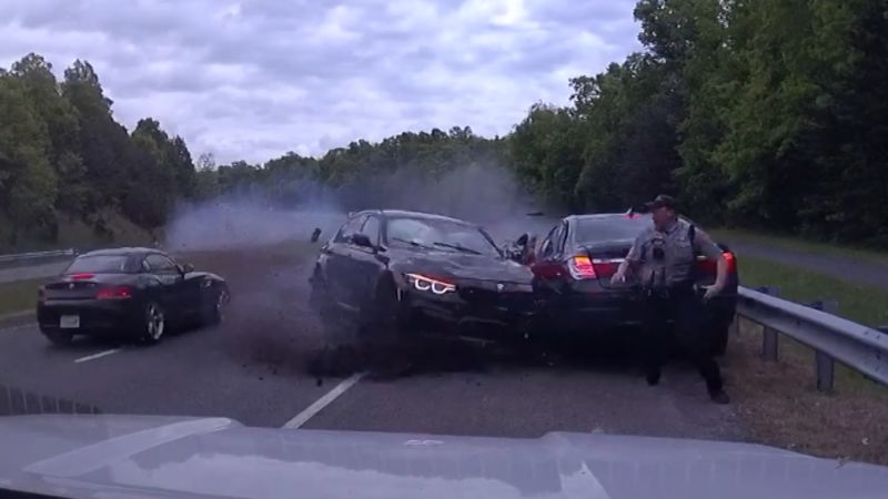 Dashcam video captures moment officer narrowly avoids BMW barrelling across highway median | CNN
