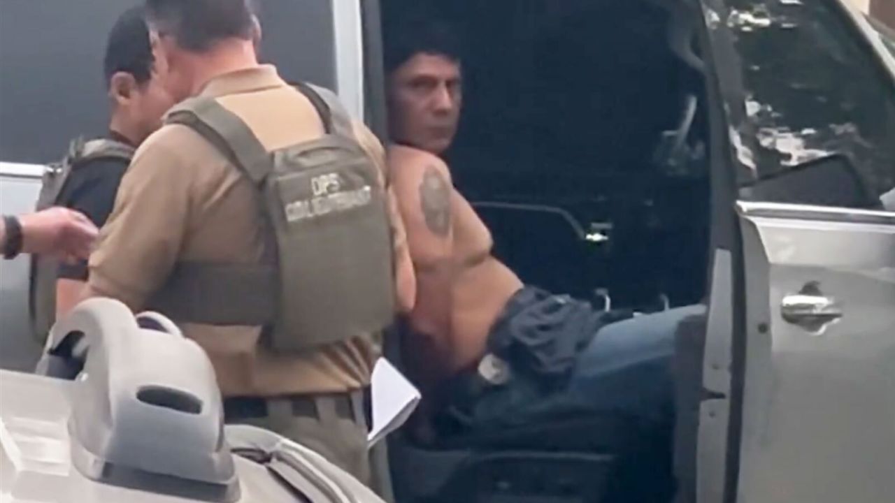 In a screengrab from video taken by a witness, Francisco Oropesa can be seen sitting in a law enforcement vehicle after being taken into custody Tuesday evening
