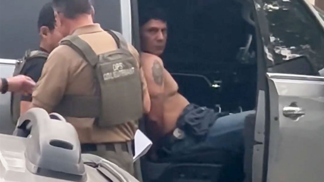 Francisco Oropesa sits in a law enforcement vehicle after being taken into custody Tuesday evening in this screengrab from video taken by a witness.