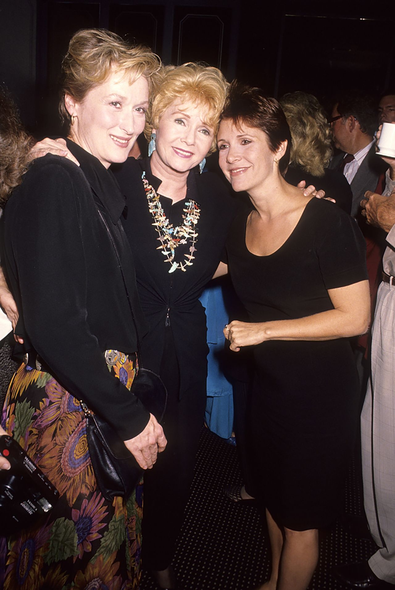 From left, Meryl Streep, Reynolds and Fisher attend the premiere of the film "Postcards from the Edge" in 1990. The film was an adaptation of Fisher's 1987 novel of the same name, and Streep played a character based on Fisher.