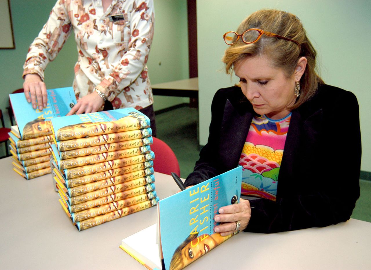 Fisher attends a book signing for her novel, "The Best Awful" in 2004. The semi-autobiographical novel fictionalized events from Fisher's life. 