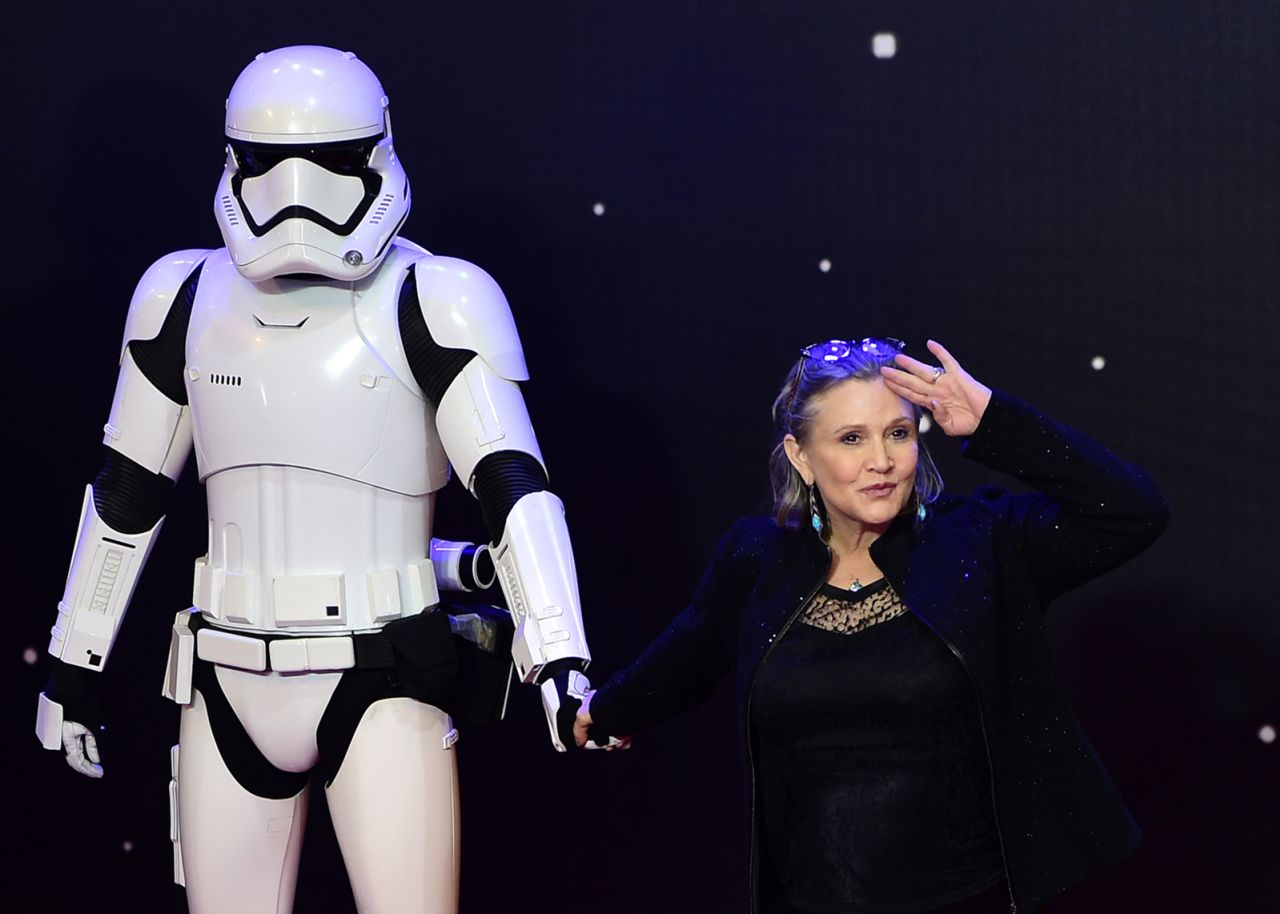 Fisher salutes next to a "Star Wars" stormtrooper at the European premiere of "Star Wars: The Force Awakens" in December 2015. Fisher played Princess Leia in the film, which was a sequel to the original "Star Wars" trilogy.