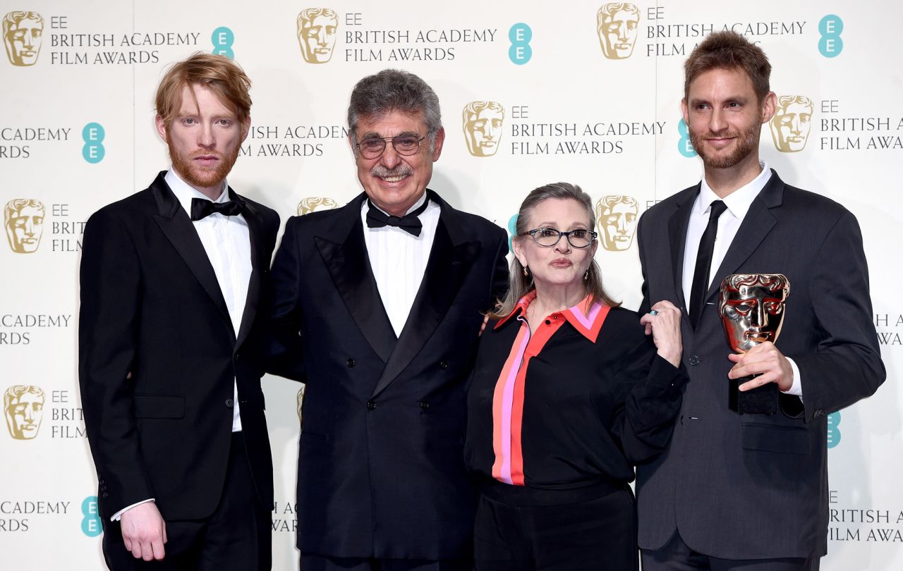 From left, Domhnall Gleeson, Hugo Sigman, Fisher and Damian Szifron pose for a photo at the British Academy Film Awards in February 2016. Their film "Wild Tales" won the BAFTA Award for best film not in the English language.