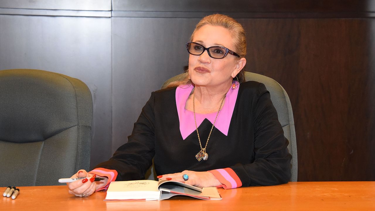 Fisher signs copies of her book "The Princess Diarist" in November 2016. She died a month later.