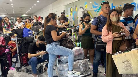 Passengers queue at an airline counter following the cancellation of flights due to a power outage, at the Terminal 3 of Ninoy Aquino International Airport, in Pasay City, Metro Manila, Philippines, May 1, 2023. 