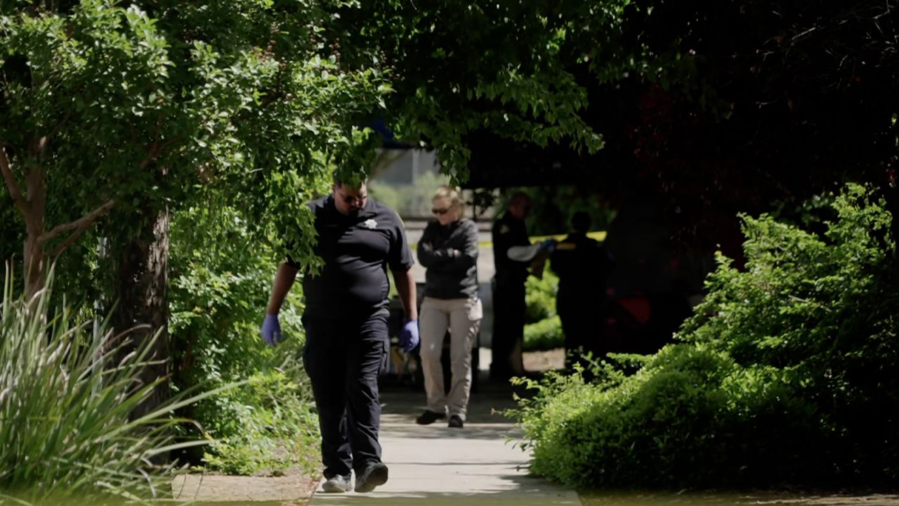 Investigators work at a crime scene in Davis, California, on May 2.