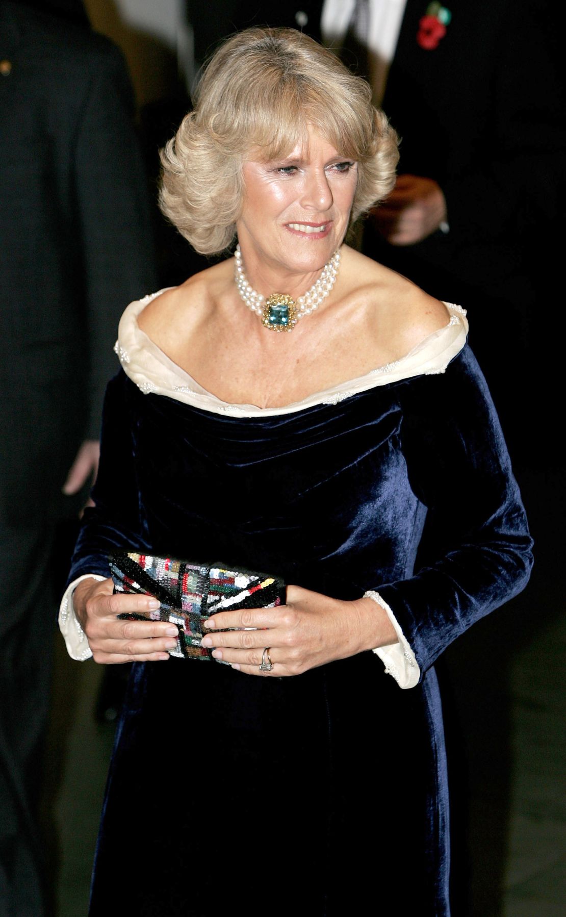 Velvet quickly became a favorite fabric for Camilla, shown here in a deep navy off-the-shoulder gown she wore to a gala at the Museum of Modern Art in New York in 2005. Her aquamarine and pearl choker is another staple.