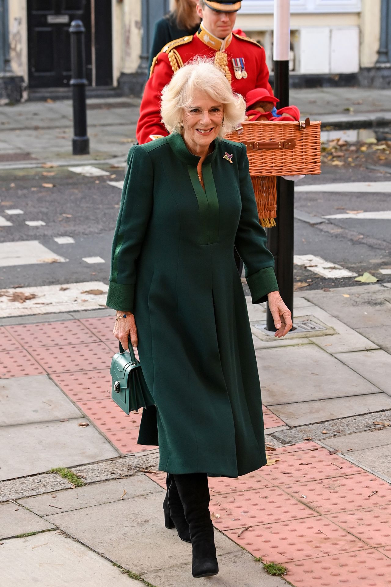 In recent years, Camilla has found her rhythm with sleek coat dresses in dark shades with small design twists — such as this mandarin collared look worn in 2022.