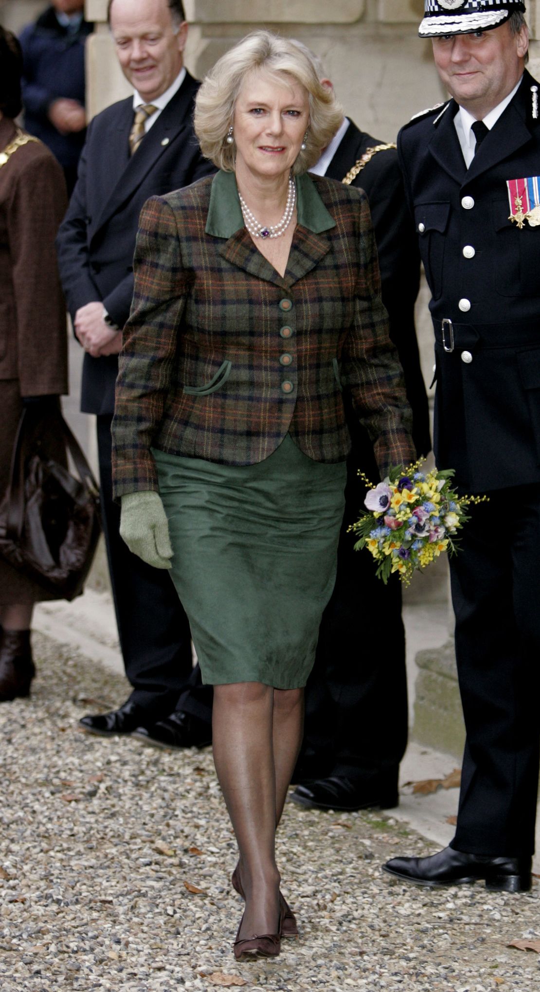 In this look from 2006, Camilla is bridging her two style identities with a country casual tartan fitted jacket (paired with a matching forest green dress) and accessorized with one her favorite styles of necklace.