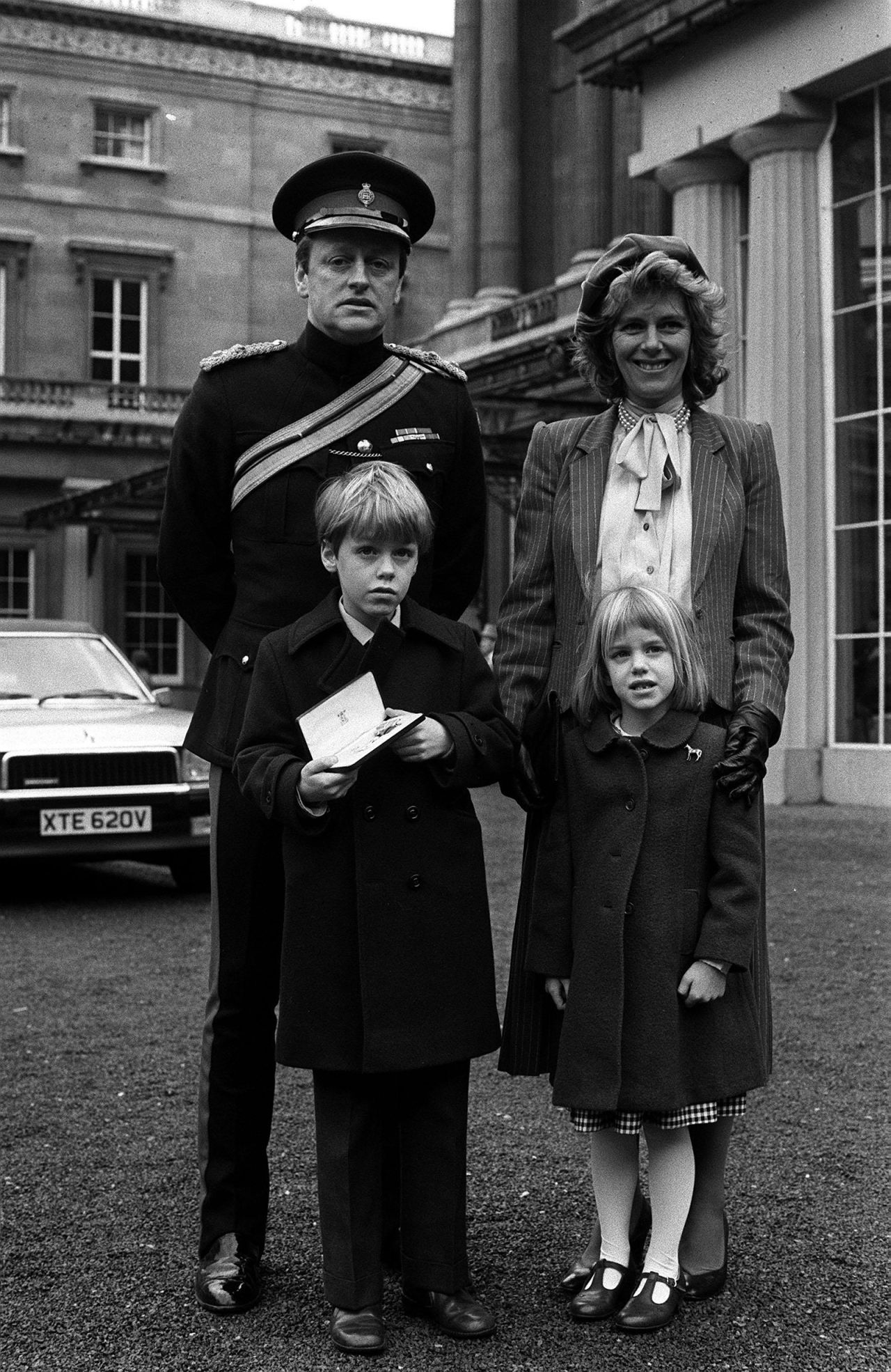 Even in 1984, the markings of Camilla's personal style were already visible. Pictured here with her first husband Andrew, son Tom and daughter Laura, Camilla's three-strand pearl necklace, structured blazer and off-center beret are pieces she has gone on to wear again and again.