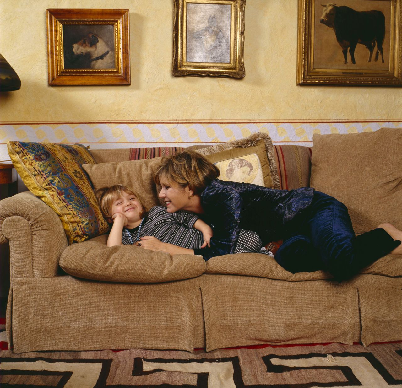 Fisher plays with her daughter, Billie Lourd, in 1997. Lourd's father is talent agent Bryan Lourd.