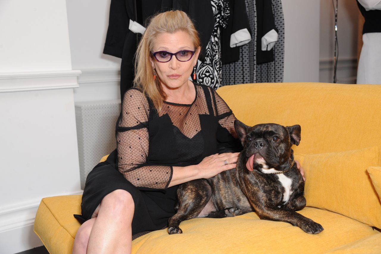 Fisher poses with her dog Gary in 2014.
