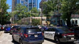 Emergency vehicles arrive on West Peachtree in Atlanta on Wednesday, May 3, 2023.  Police say are investigating an "active shooter situation" in a building in Atlanta's Midtown neighborhood and that multiple people had been injured. (AP Photo/Jeff Amy)