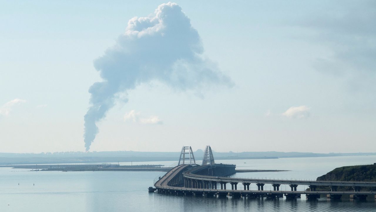 A view across the Kerch Strait shows smoke rising above a fuel depot near the Crimean bridge in the village of Volna in Russia's Krasnodar region, as seen from a coastline in Crimea, on May 3, 2023.