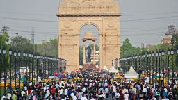 People crowd as they visit the India Gate in New Delhi on April 23, 2023. 