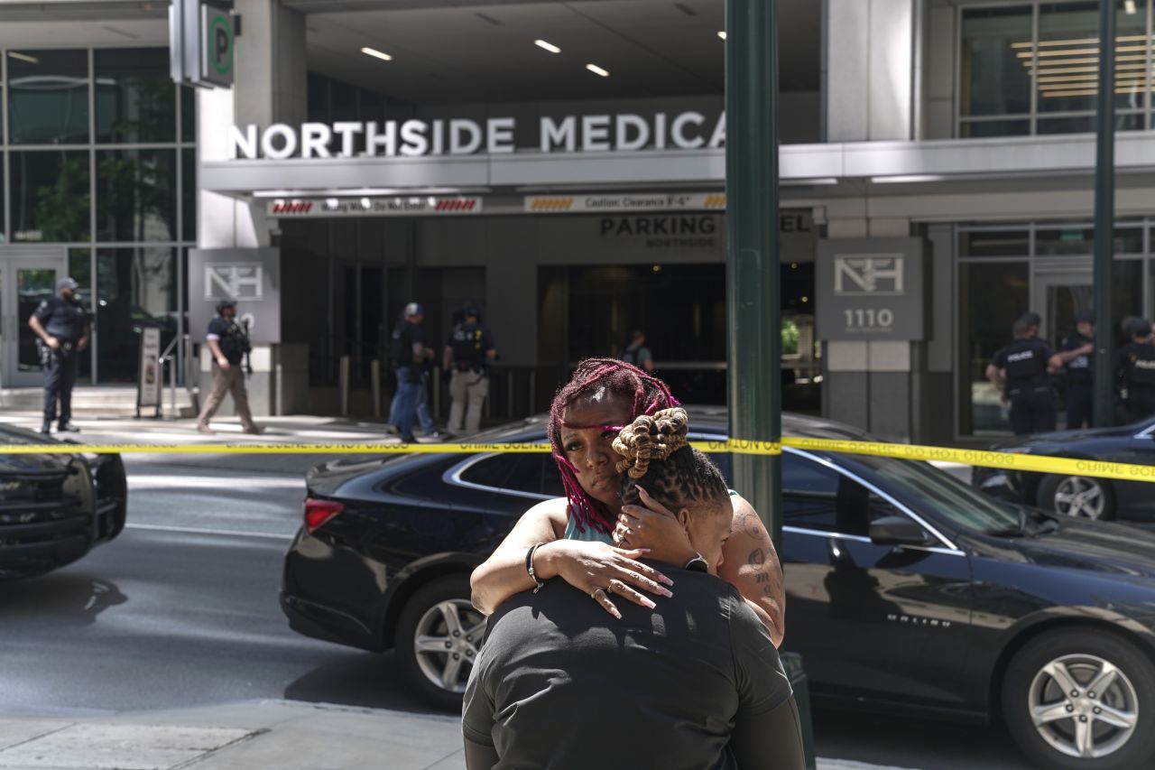 Angela Cooper and Jamese Nathan embrace outside of the Northside Medical Midtown facility as police officers work the scene of a shooting there on Wednesday, May 3.