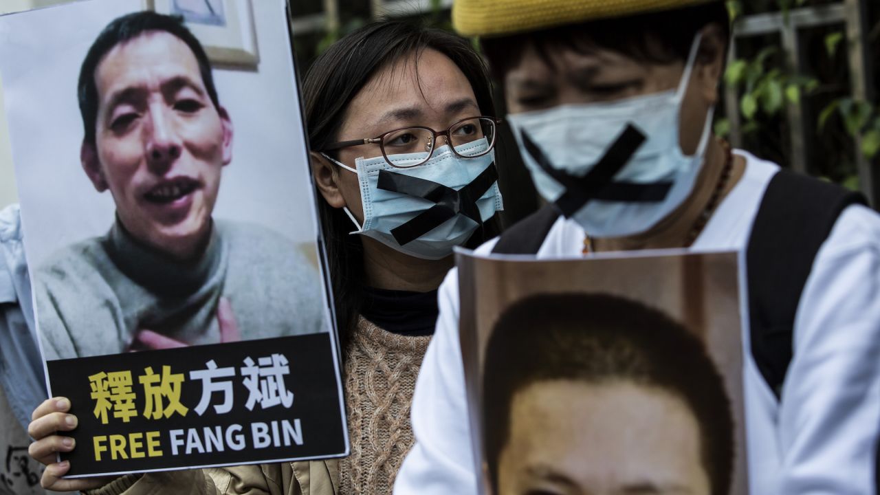 A pro-democracy activist in Hong Kong holds a placard of missing citizen journalist Fang Bin, during a February 2020 protest. 