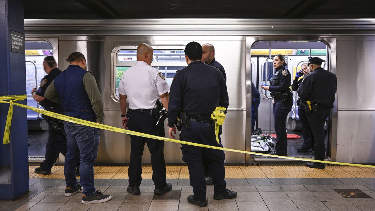 New York police officers respond after a man riding the subway was placed in a chokehold by another passenger on Monday