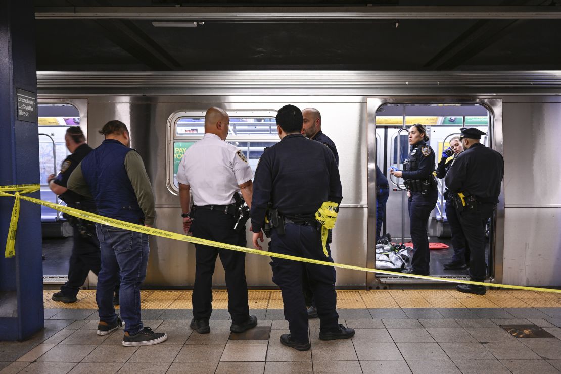 New York police officers respond after a man riding the subway was placed in a chokehold by another passenger on Monday.