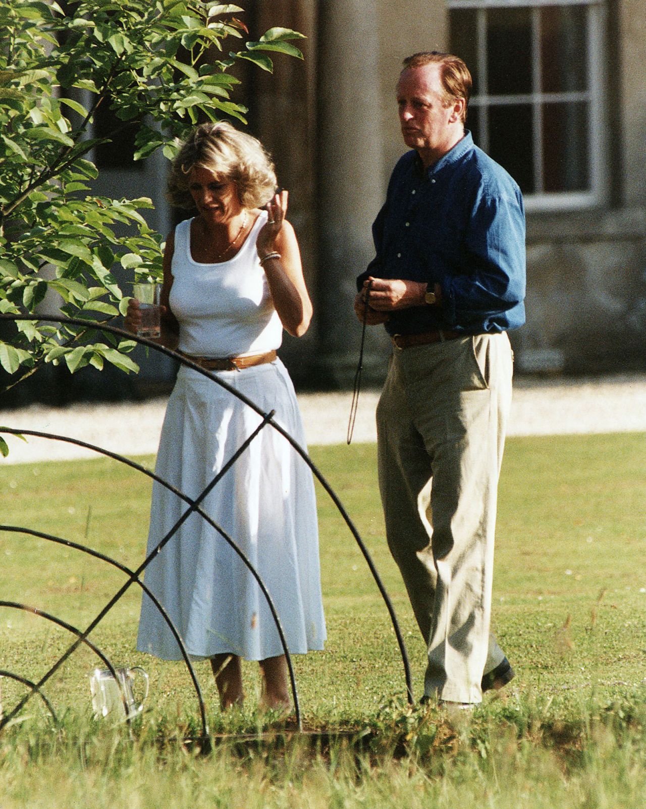 Similary, during the summer of 1993 Camilla's personal style was remarkably relatable. Like this white tank top and linen maxi skirt. Here, she's photographed outside with her first husband, Andrew.