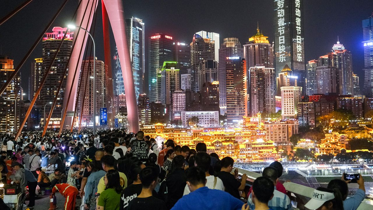 Tourists flock to the Qiansimen Jialing River Bridge during the May Day holiday on May 1, 2023, in Chongqing, China.