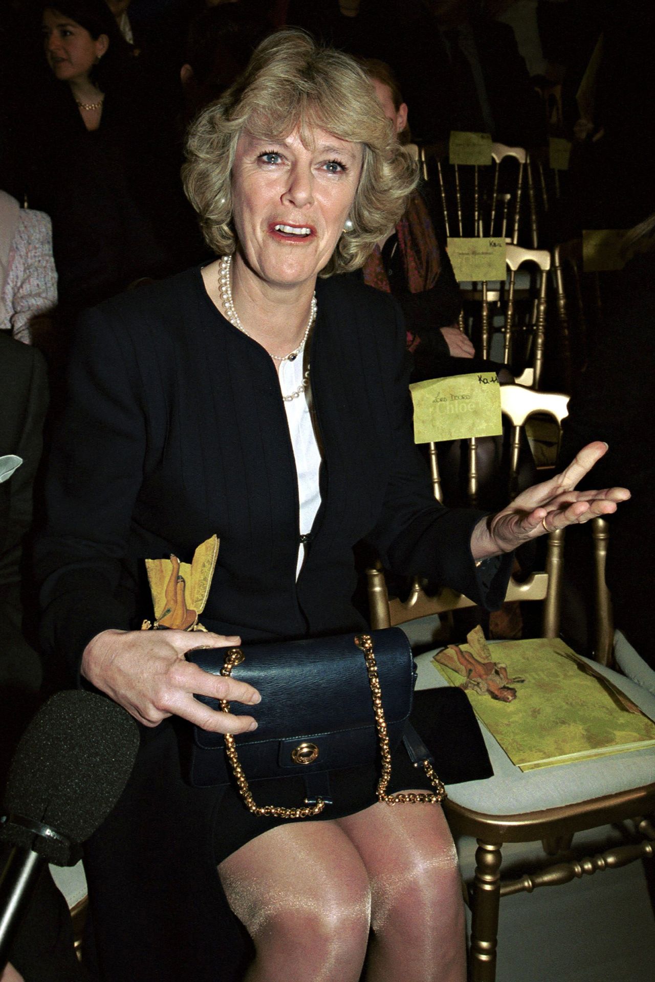 Long before it was expected that Camilla publicly support British creative exports, she was seen cheering on Stella McCartney during her Fall-Winter 2000 show for Chloé at Paris Fashion Week. Perched on her knee was a black leather Chloé Epi crossbody bag, with a gold chain strap and clasp.