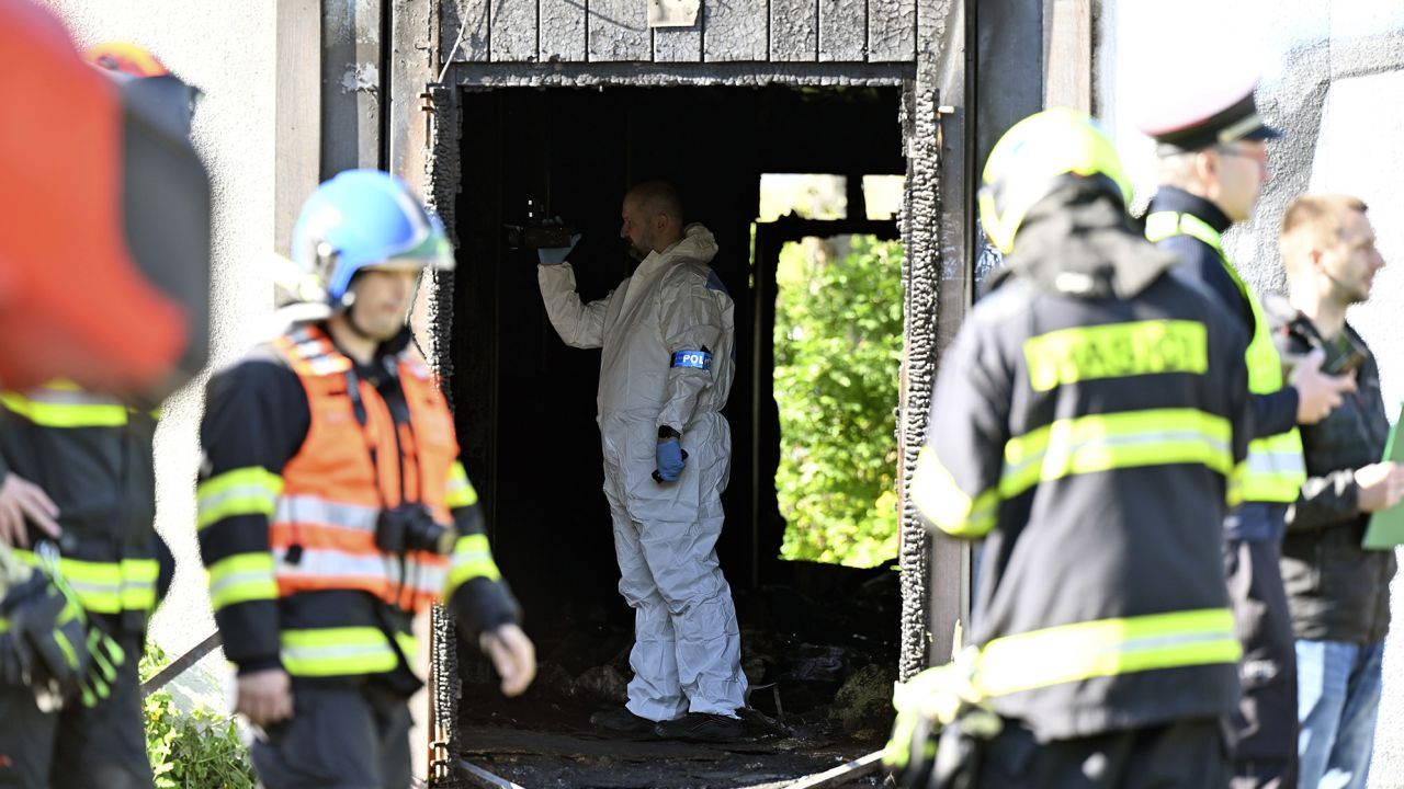 Firefighters and police investigators gather at the scene of a fatal fire in Plotni Street in Brno, Czech Republic, on Thursday, May 4, 2023. 
