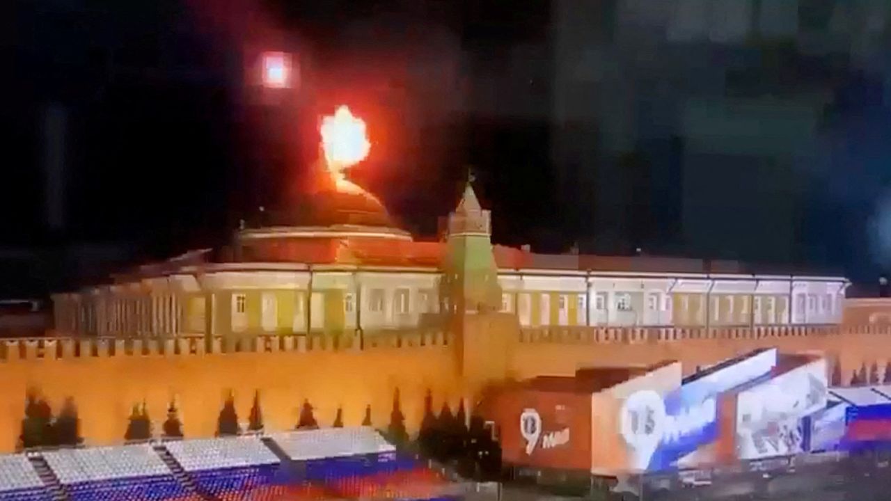 A still image taken from video shows a flying object exploding in an intense burst of light near the dome of the Kremlin.