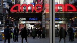 NEW YORK, NEW YORK - MARCH 29: People make their way near an AMC Theatre on March 29, 2023 in New York City. AMC Entertainment shares jumped as much as 13%, following a report that Amazon was looking to buy the theater chain. 