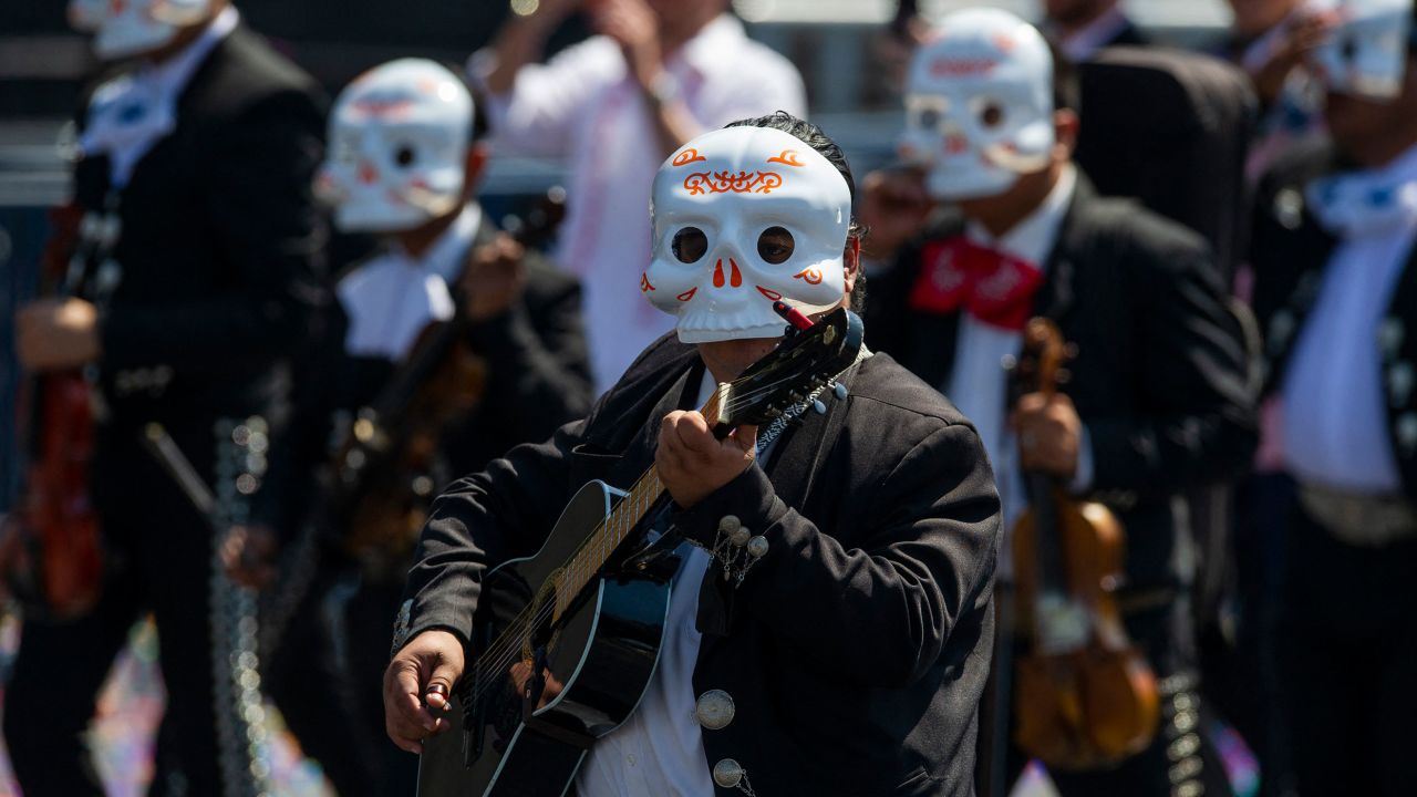 Mariachis take part in a Day of the Dead parade in Mexico City on October 31, 2021.