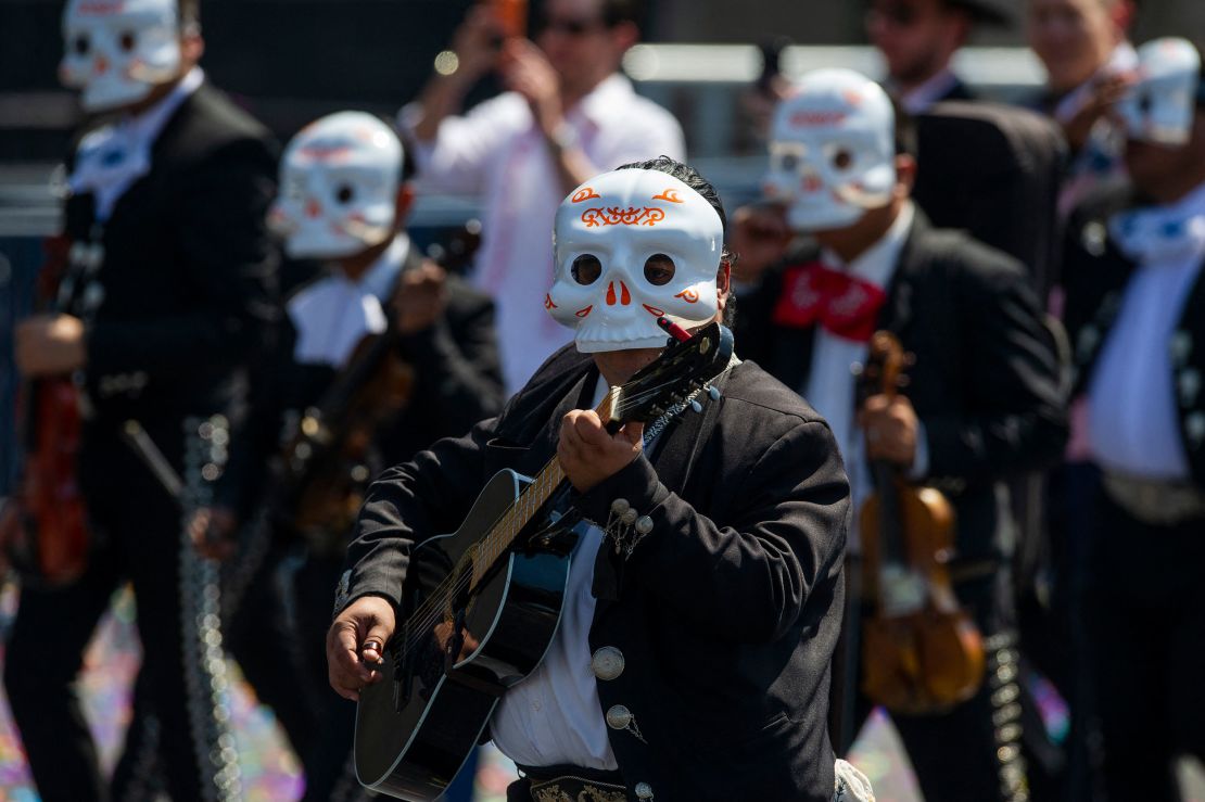 Mariachis take part in a Day of the Dead parade in Mexico City on October 31, 2021. 